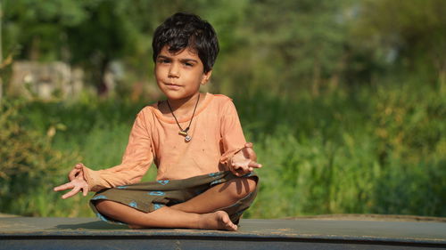 Indian kids doing yoga pose in the park outdoor. healthy life style concept.