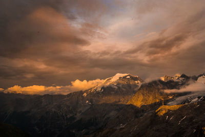 Scenic view of snowcapped mountains against sky during sunset