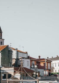 Buildings in city against clear sky