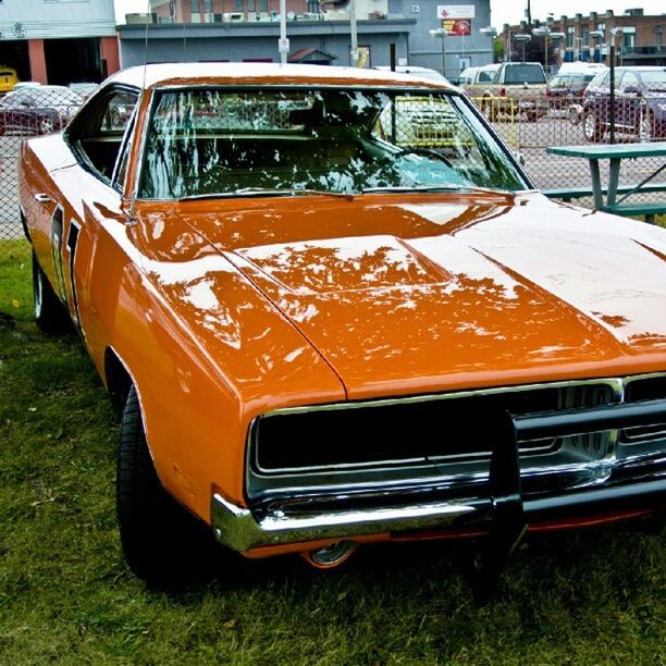 transportation, car, mode of transport, land vehicle, street, yellow, travel, stationary, vehicle, road, outdoors, headlight, vintage car, day, parking, no people, bus, close-up, building exterior, sunlight