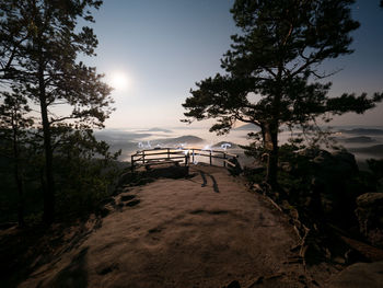 Full moon and sunset on mountain. misty autumn lightpainting in cold full moon light. vilemina rock