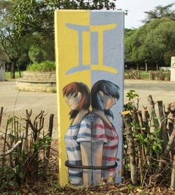 Rear view of man standing against plants