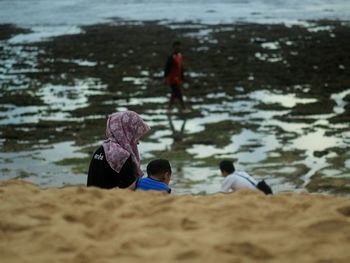 Rear view of men on beach