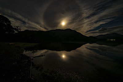 Scenic view of lake against sky at night