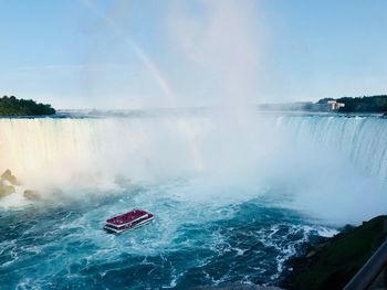 Scenic view of waterfall against sky