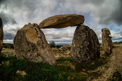 Panoramic view of rocks on shore against sky