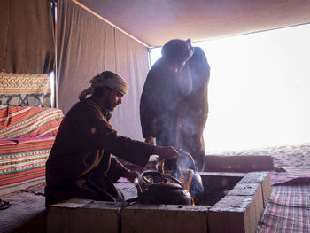 Man working on barbecue grill