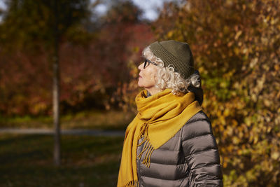 Portrait of senior woman in autumn scenery