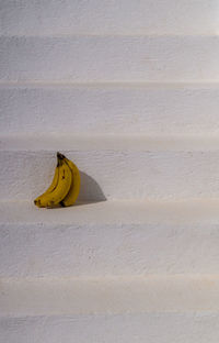 Yellow bananas on white stairs 