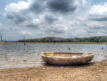 Boat on shore against sky