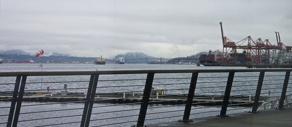 Commercial dock by sea against sky