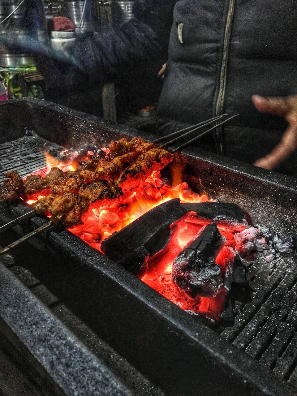 CLOSE-UP OF MEAT COOKING ON BARBECUE