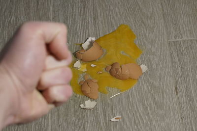 Close-up of hand holding yellow leaf