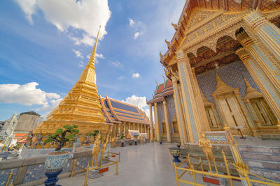 Low angle view of temple amidst buildings against sky