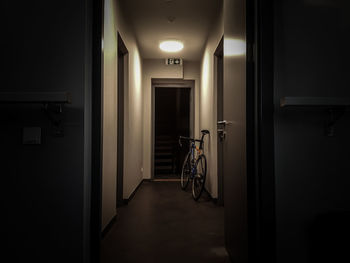 Bicycle parked in illuminated corridor