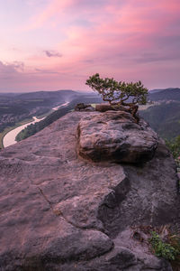 Rock formation on land against sky during sunset