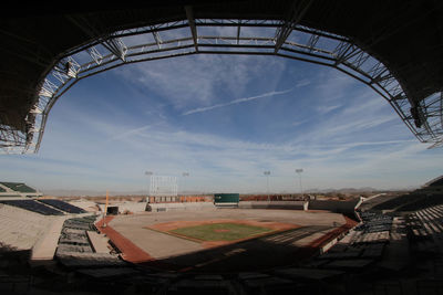 Soccer field in city against sky