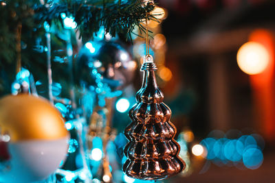 Close-up of decoration hanging on christmas tree with illuminated lights