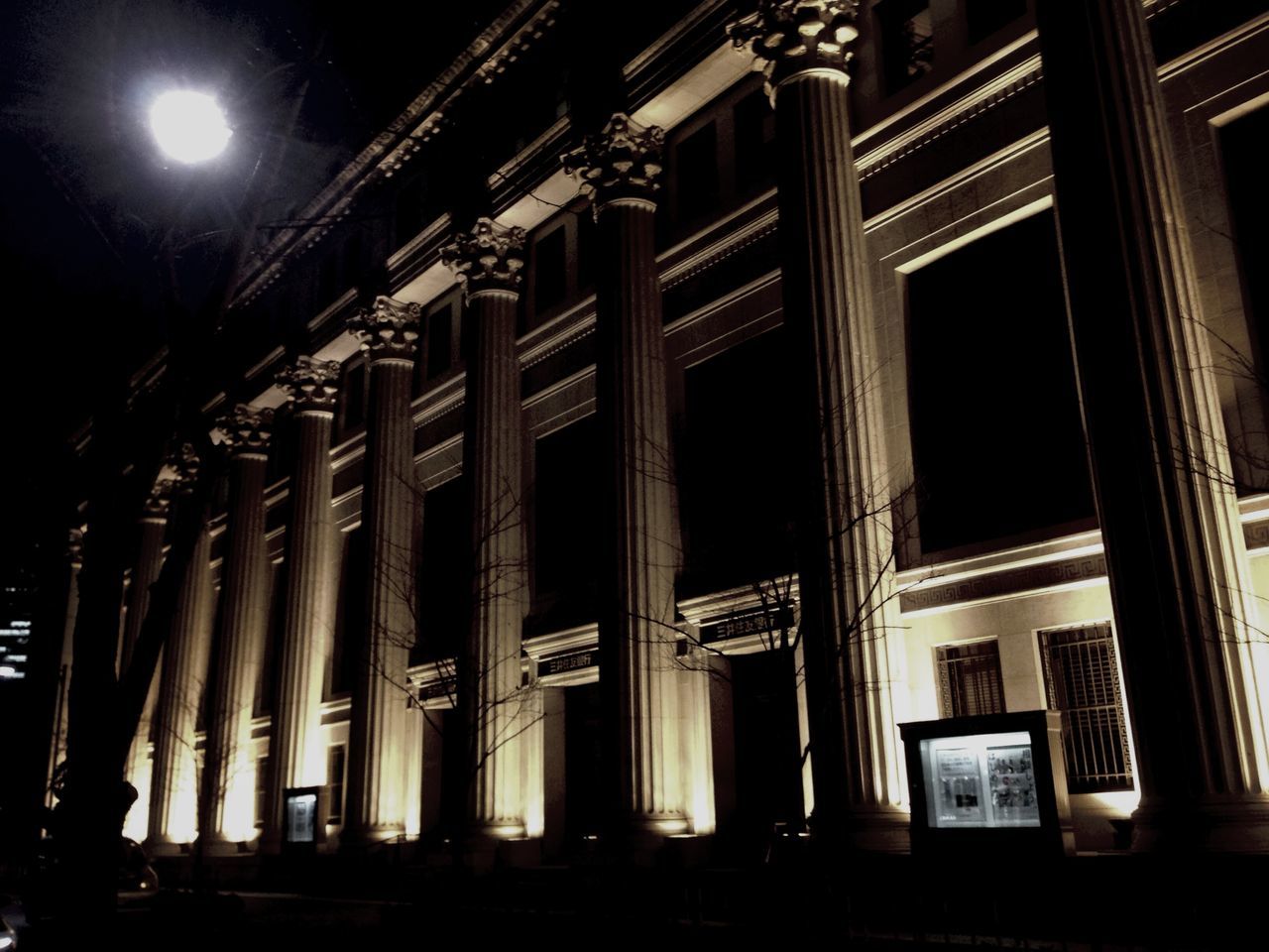 night, architecture, illuminated, built structure, low angle view, building exterior, lighting equipment, street light, window, building, architectural column, light - natural phenomenon, column, in a row, dark, no people, sky, clear sky, electric light, outdoors