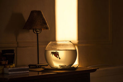 Close-up of illuminated lamp on table