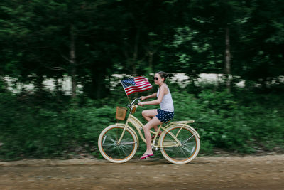 Rear view of man riding bicycle