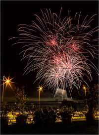 Low angle view of firework display at night