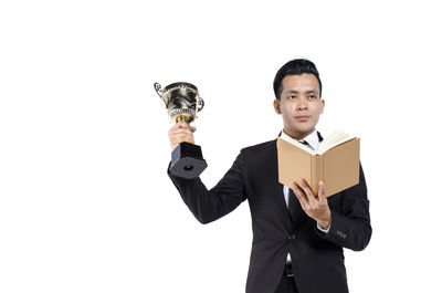 Young man with arms outstretched against white background