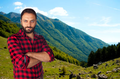 Portrait of young man standing on mountain