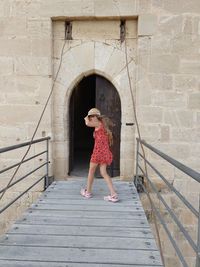 Full length of girl standing on footbridge