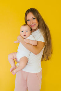 Loving mother takes care of a newborn baby at home. portrait of a happy mother holding a sweet son