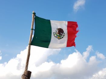 Low angle view of mexican flag against blue sky