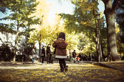 Rear view of girl walking in park