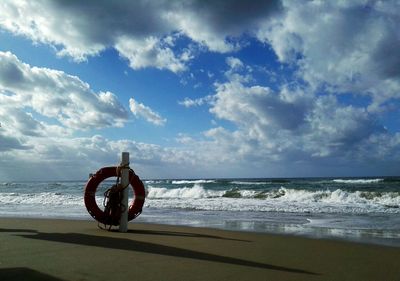 Bicycle on beach against sky