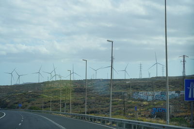 Road passing through land against sky