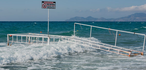 Broken bathing place with waves overflowing in storm in the mediterranean, on kos greece