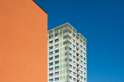 Low angle view of modern building against clear blue sky
