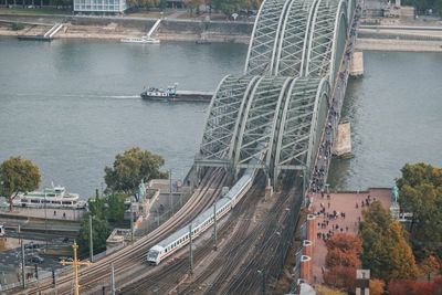 High angle view of railroad tracks by river in city