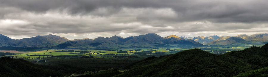 Scenic view of mountains against cloudy sky