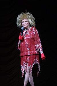 Full length of woman standing against black background