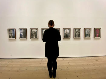 Rear view of woman standing in museum