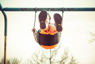 Man playing with swing in park