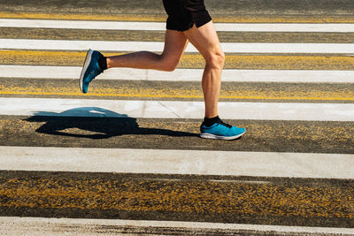 Low section of woman walking on footpath