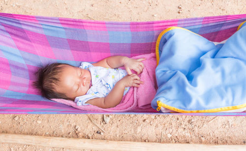 Cute baby girl sleeping on bed