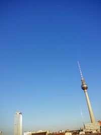 Low angle view of fernsehturm against clear blue sky