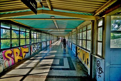 Rear view of people walking on footbridge