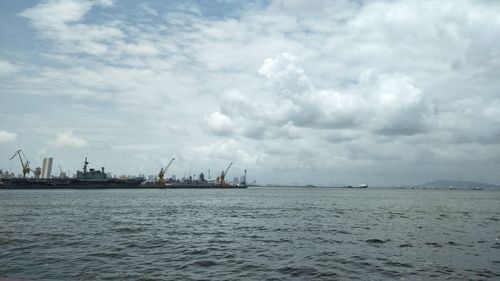 Sailboats in sea against sky