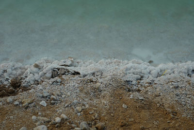 High angle view of frozen stone with water