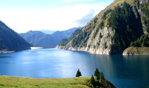 Scenic view of lake and mountains against sky