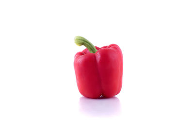 Close-up of red bell peppers against white background