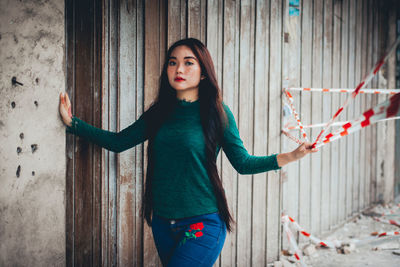 Portrait of woman holding cordon tape